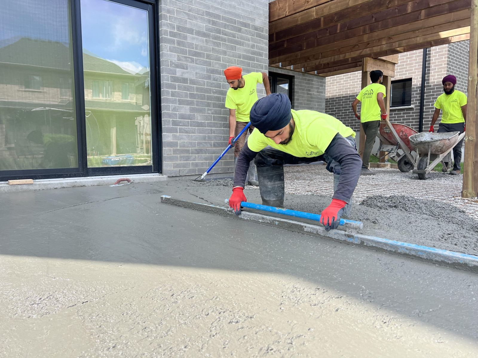 Century Construction crew finishing a concrete pour on site